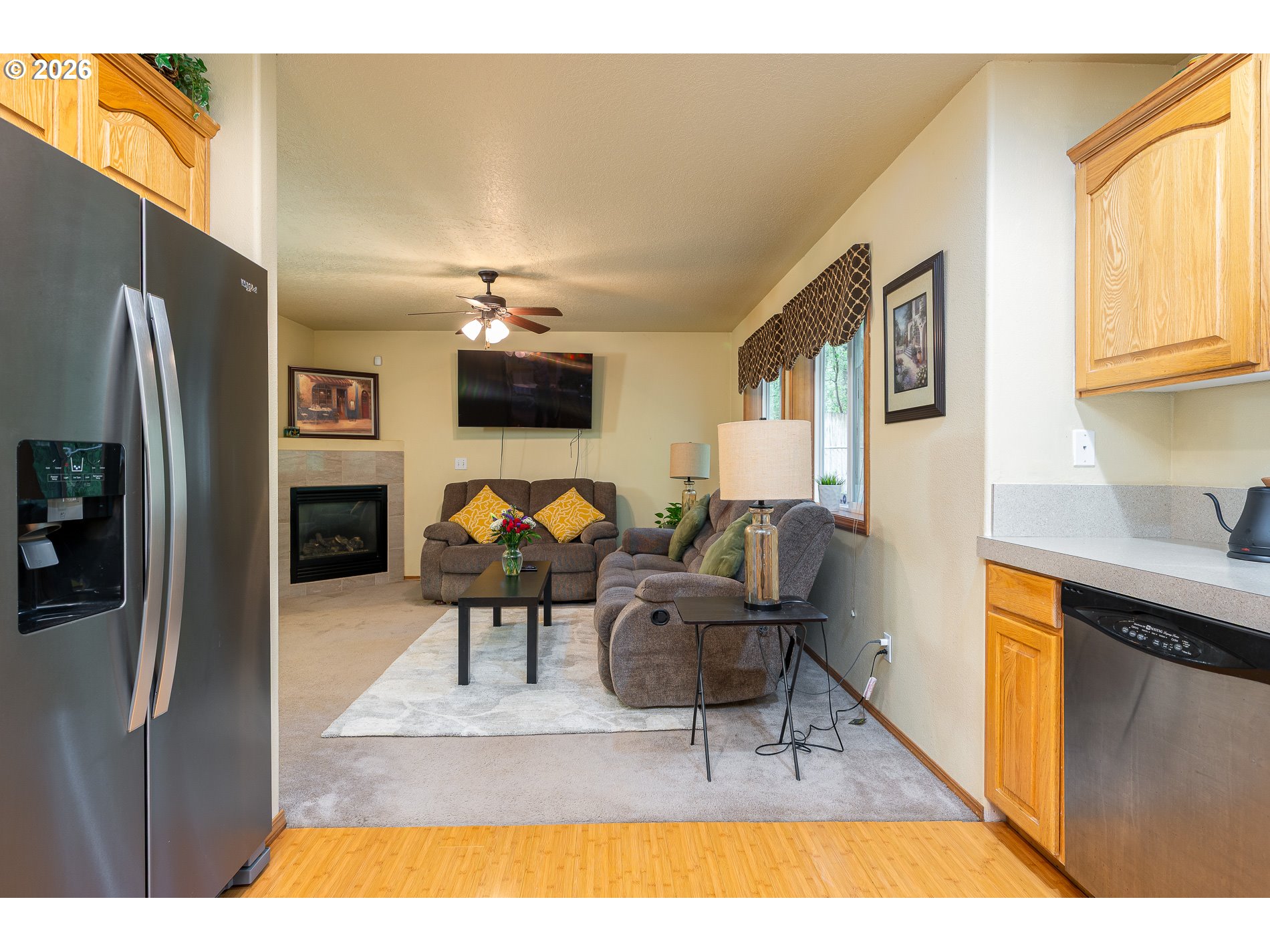 14300 Southeast Center Street Portland, OR 97236 - Photo 11 of 48 a living room with furniture a flat screen tv and a refrigerator