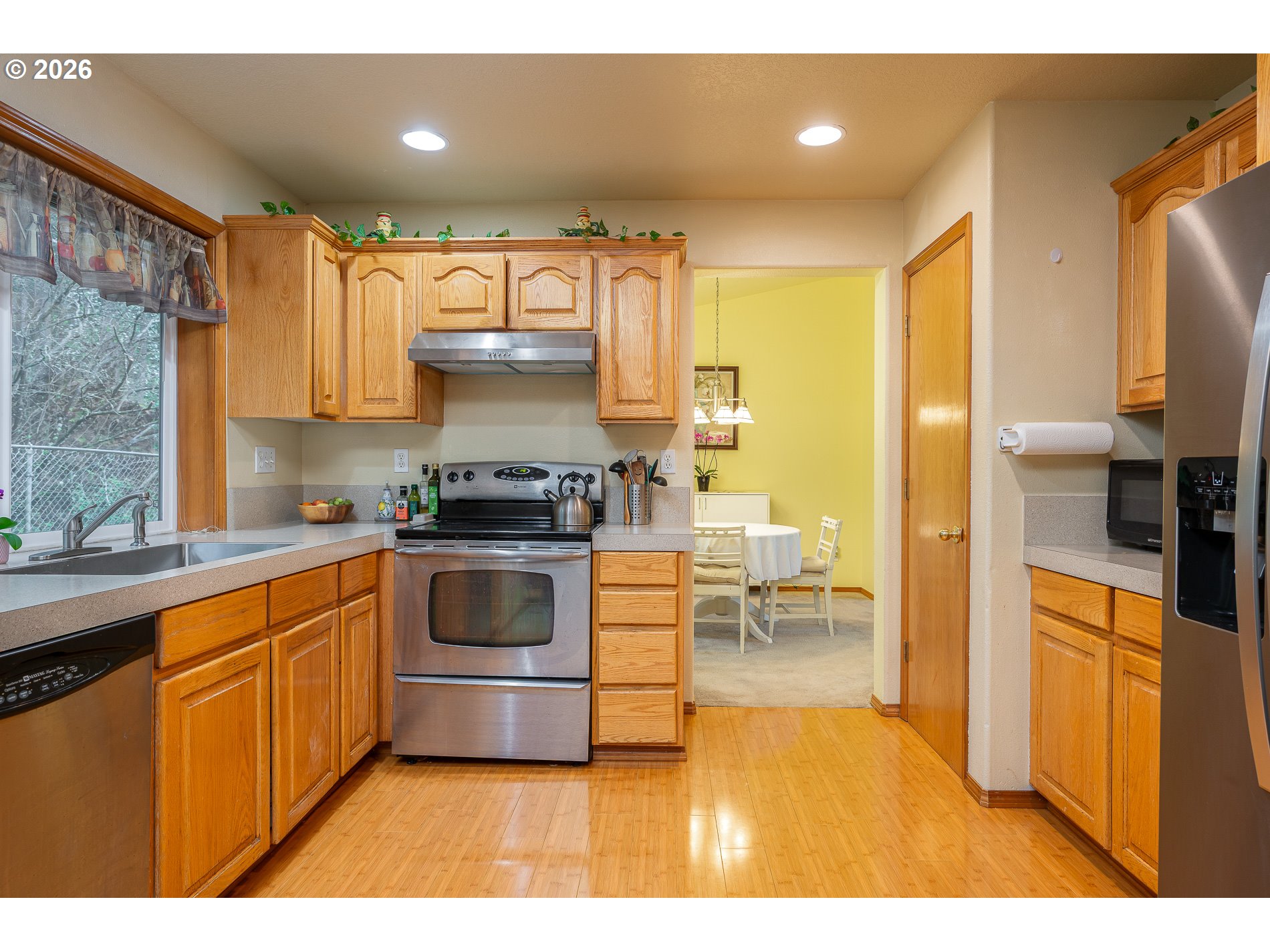 14300 Southeast Center Street Portland, OR 97236 - Photo 13 of 48 a kitchen with stainless steel appliances a stove a sink and a refrigerator