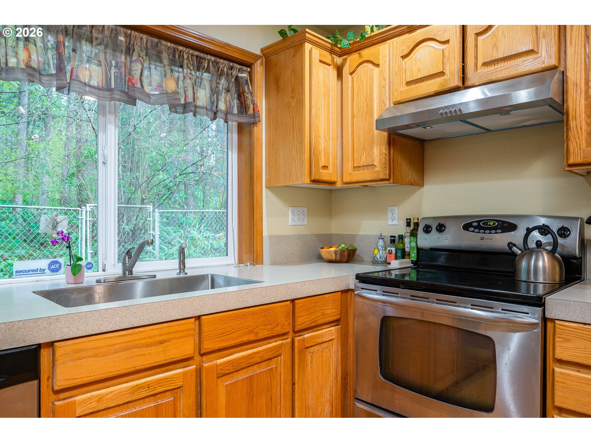 14300 Southeast Center Street Portland, OR 97236 - Photo 14 of 48 a kitchen with stainless steel appliances granite countertop a sink a stove and a microwave