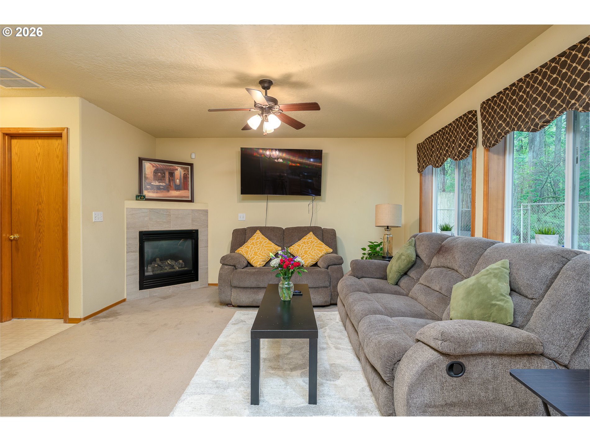 14300 Southeast Center Street Portland, OR 97236 - Photo 17 of 48 a living room with furniture a flat screen tv and a fireplace