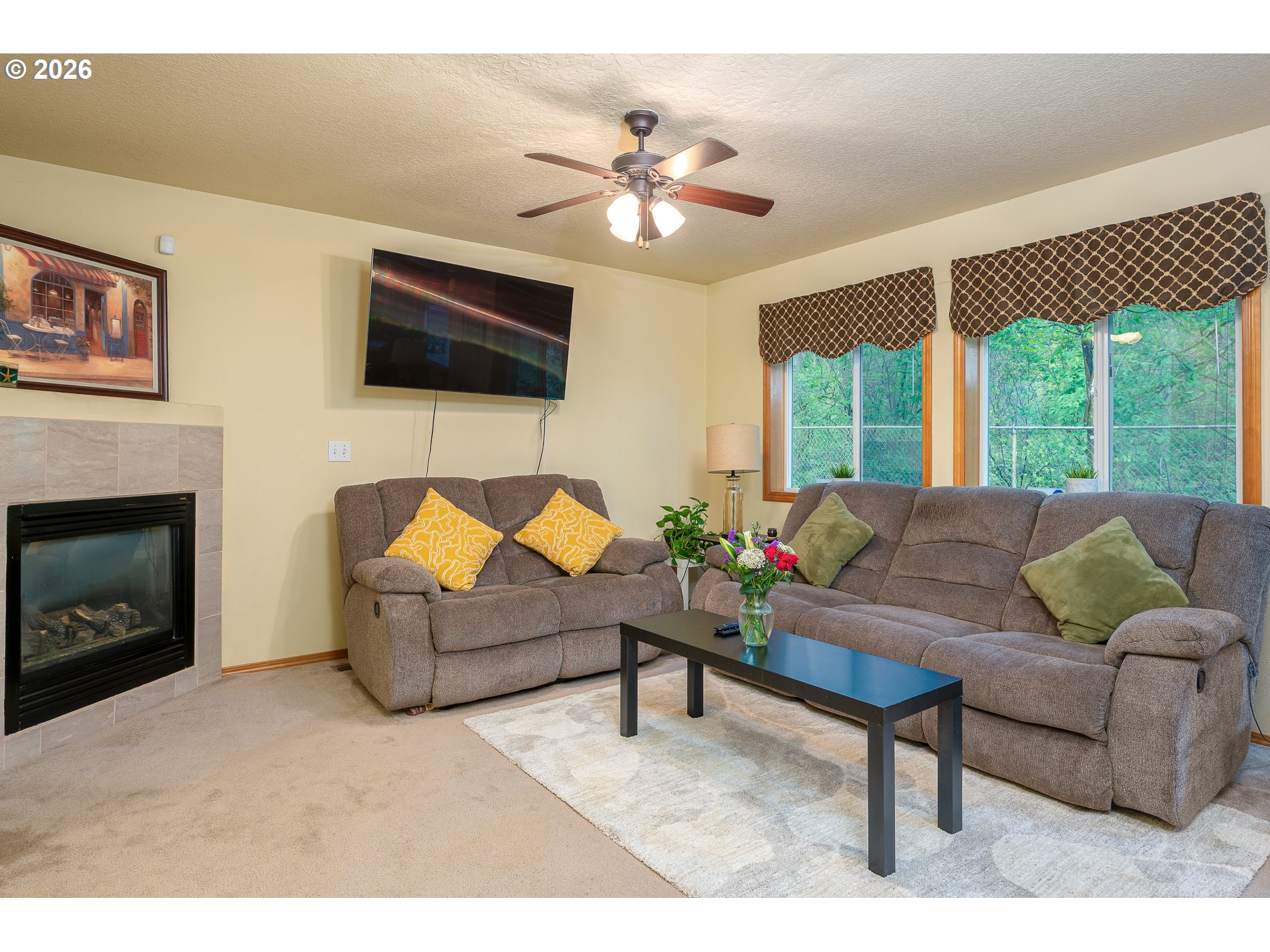 14300 Southeast Center Street Portland, OR 97236 - Photo 18 of 48 a living room with furniture a flat screen tv and a fireplace