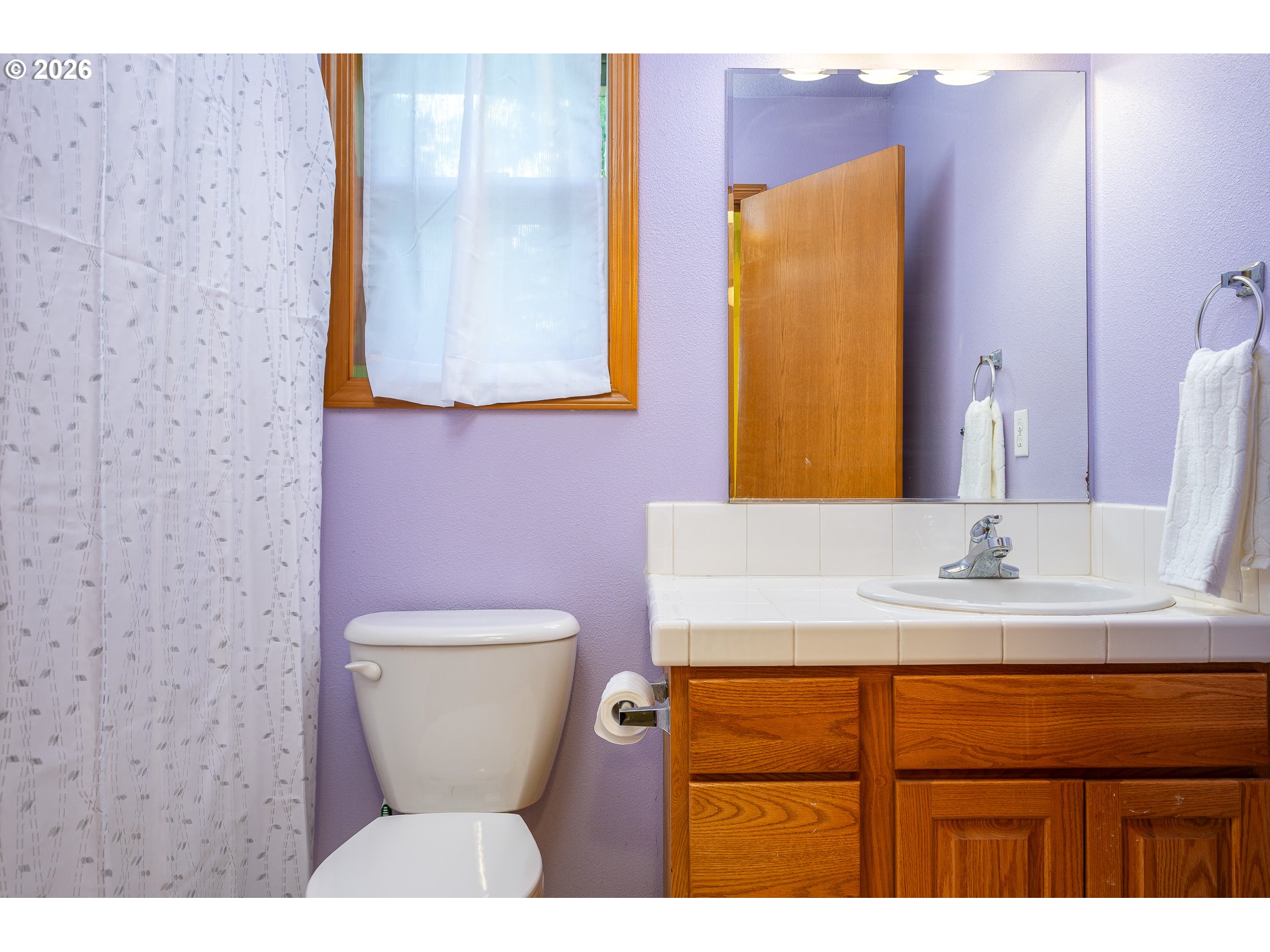 14300 Southeast Center Street Portland, OR 97236 - Photo 27 of 48 a bathroom with a sink a toilet and mirror
