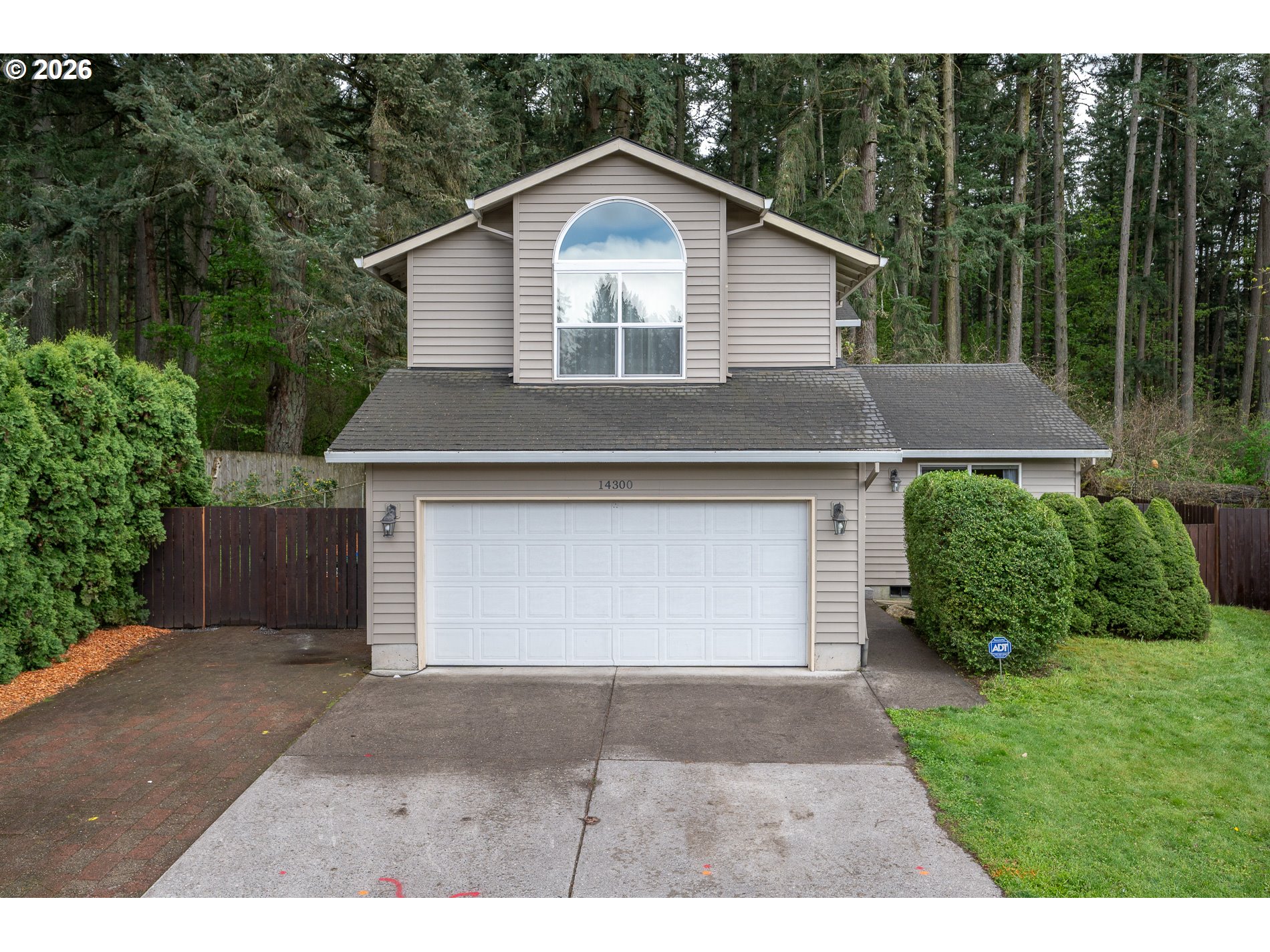 14300 Southeast Center Street Portland, OR 97236 - Photo 3 of 48 a front view of a house with a yard and garage