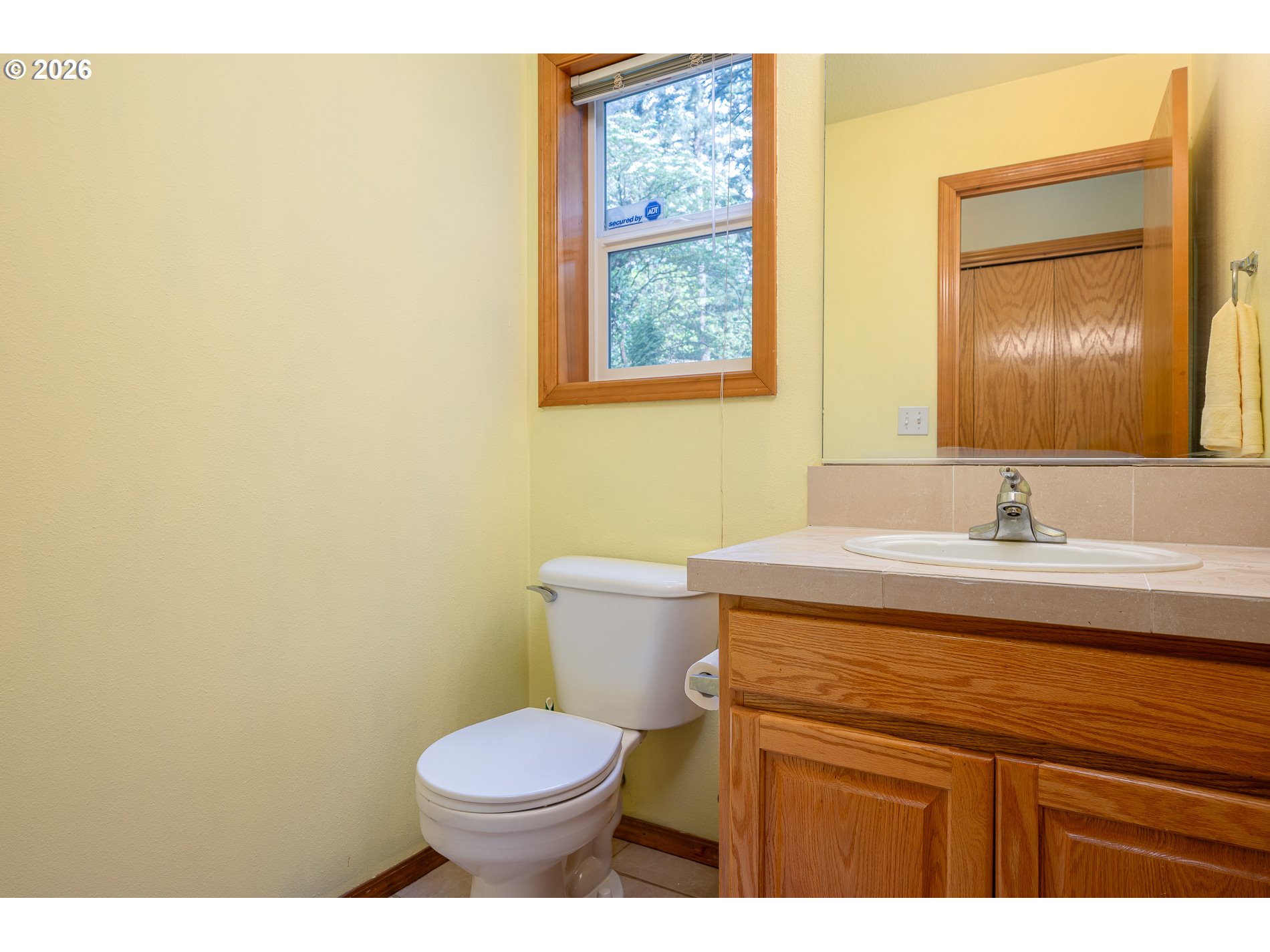 14300 Southeast Center Street Portland, OR 97236 - Photo 31 of 48 a bathroom with a granite countertop toilet sink and mirror