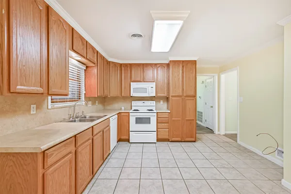a kitchen with a stove a sink and a refrigerator