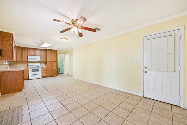 a view of a kitchen with microwave and furniture