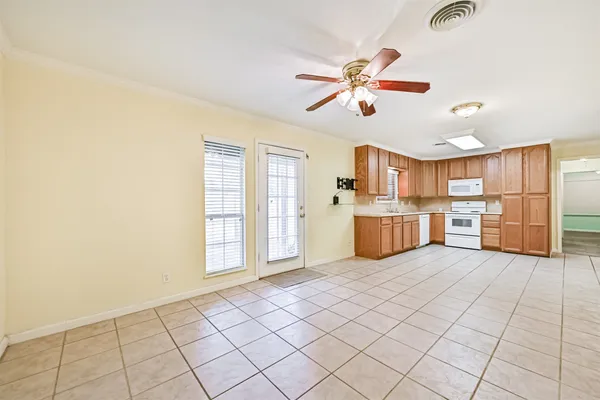 a view of a kitchen with furniture and wooden floor