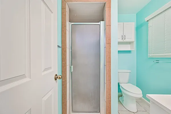 a white toilet sitting next to a bathroom sink