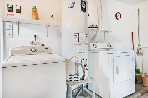 a bathroom with a sink a washer and dryer