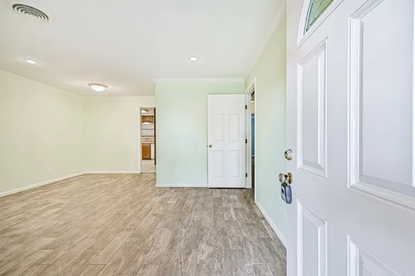 a view of a hallway with wooden floor and staircase
