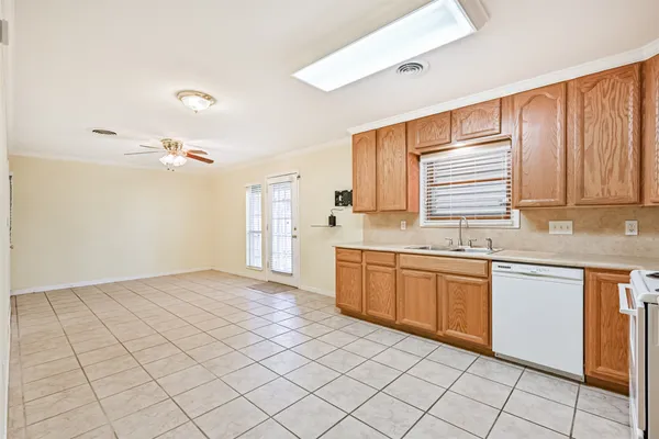a kitchen with a sink cabinets and window