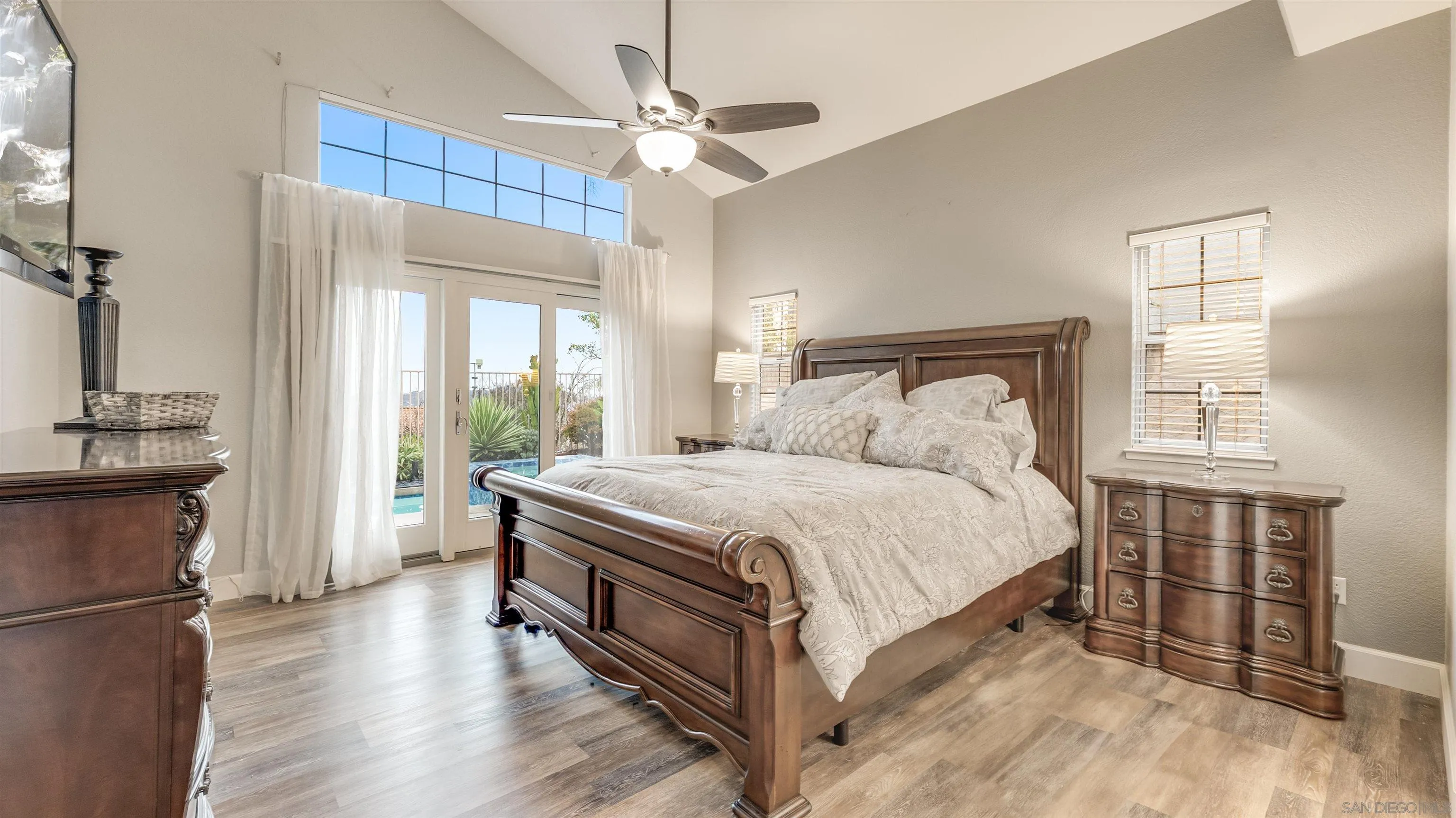 2352 Rock Crest Glen Escondido, CA 92026 - Photo 18 of 48 a bed room with a bed and a chandelier