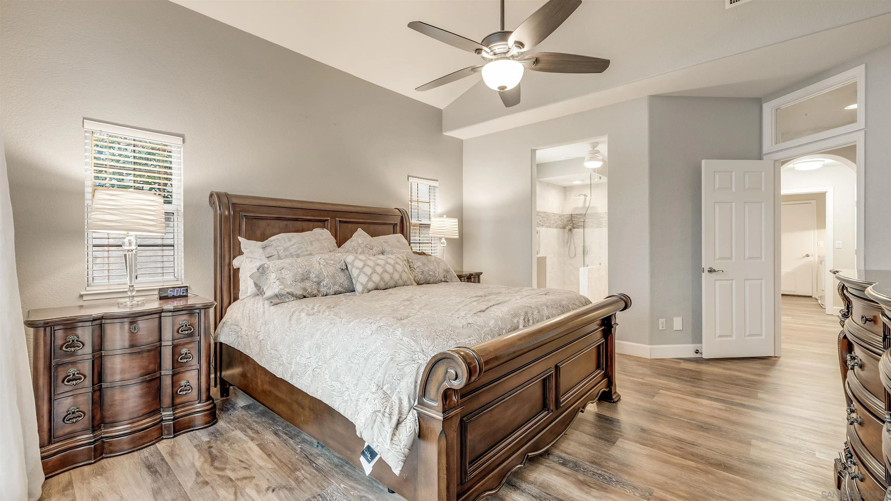 2352 Rock Crest Glen Escondido, CA 92026 - Photo 19 of 48 a spacious bedroom with a bed and a chandelier