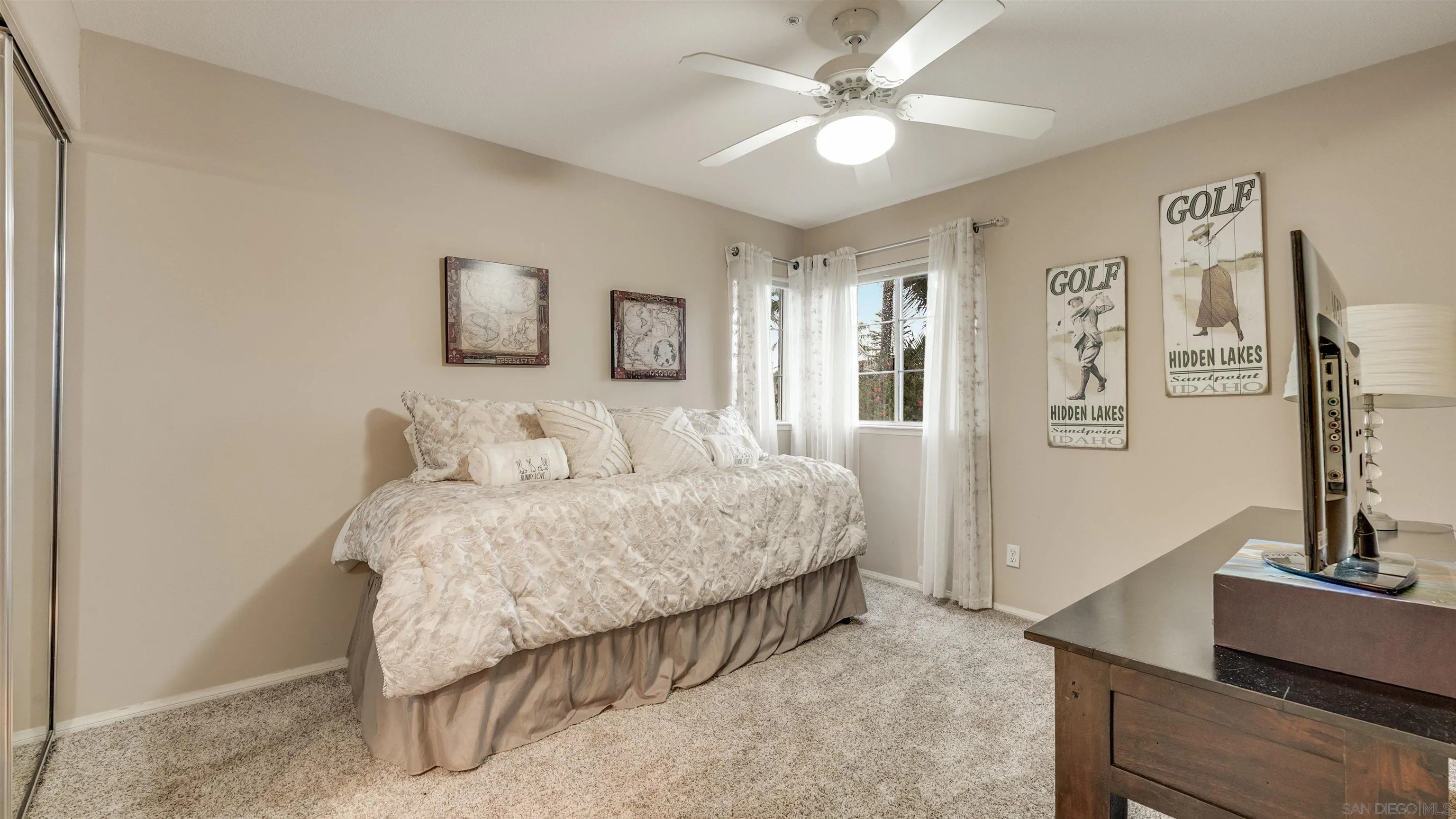 2352 Rock Crest Glen Escondido, CA 92026 - Photo 29 of 48 a spacious bedroom with a bed a couch and a chandelier