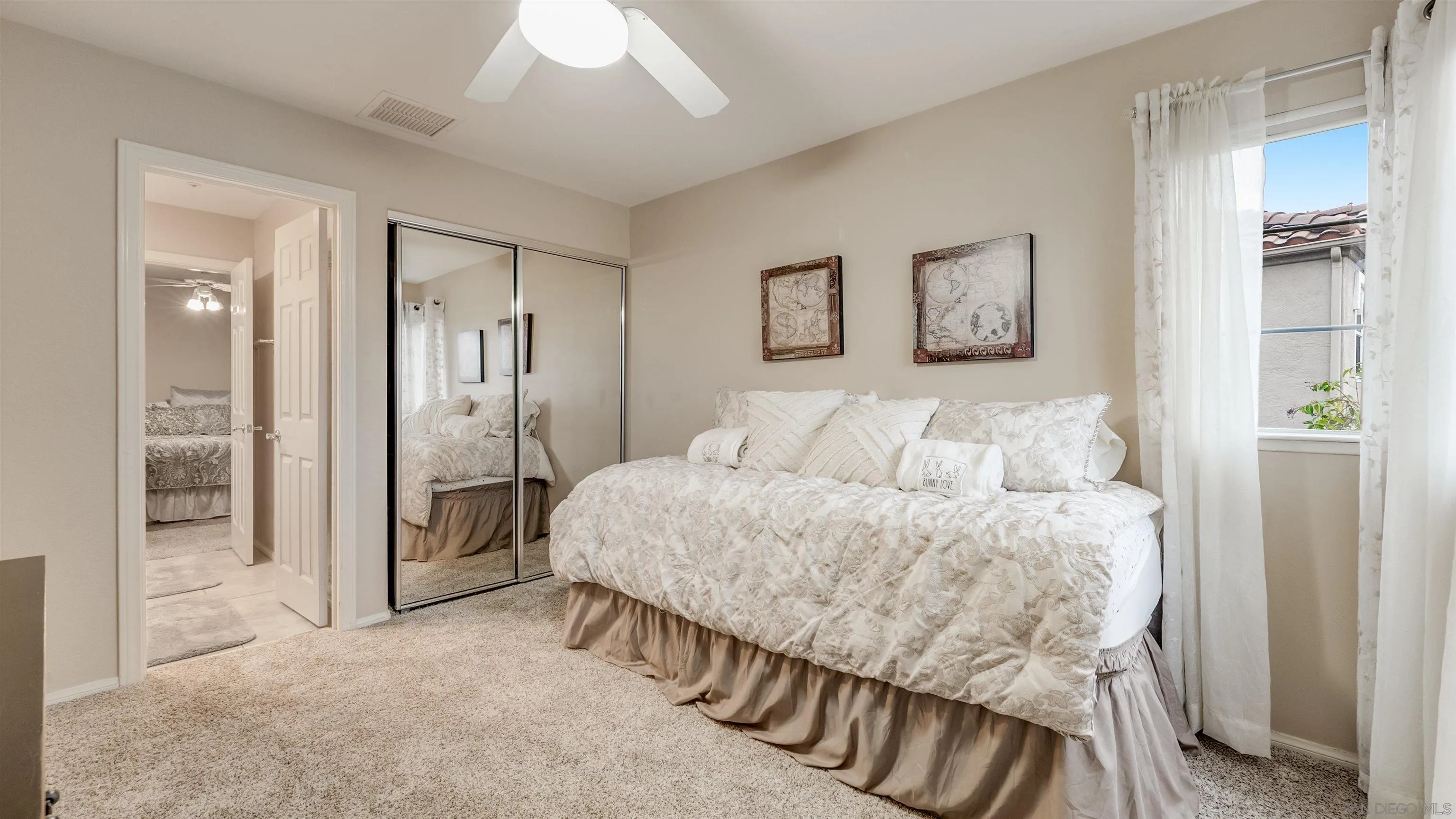 2352 Rock Crest Glen Escondido, CA 92026 - Photo 30 of 48 a spacious bedroom with a bed and a chandelier