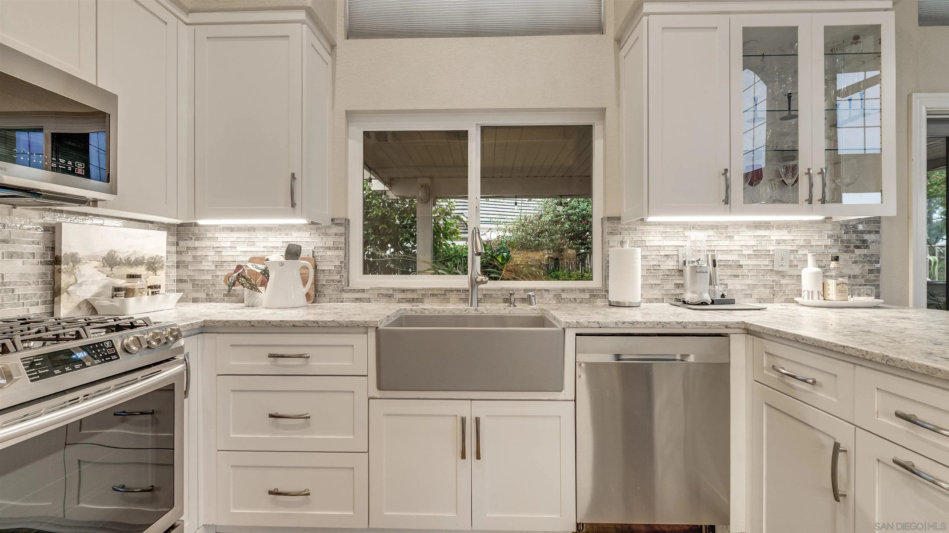 2352 Rock Crest Glen Escondido, CA 92026 - Photo 37 of 48 a kitchen with granite countertop white cabinets and window