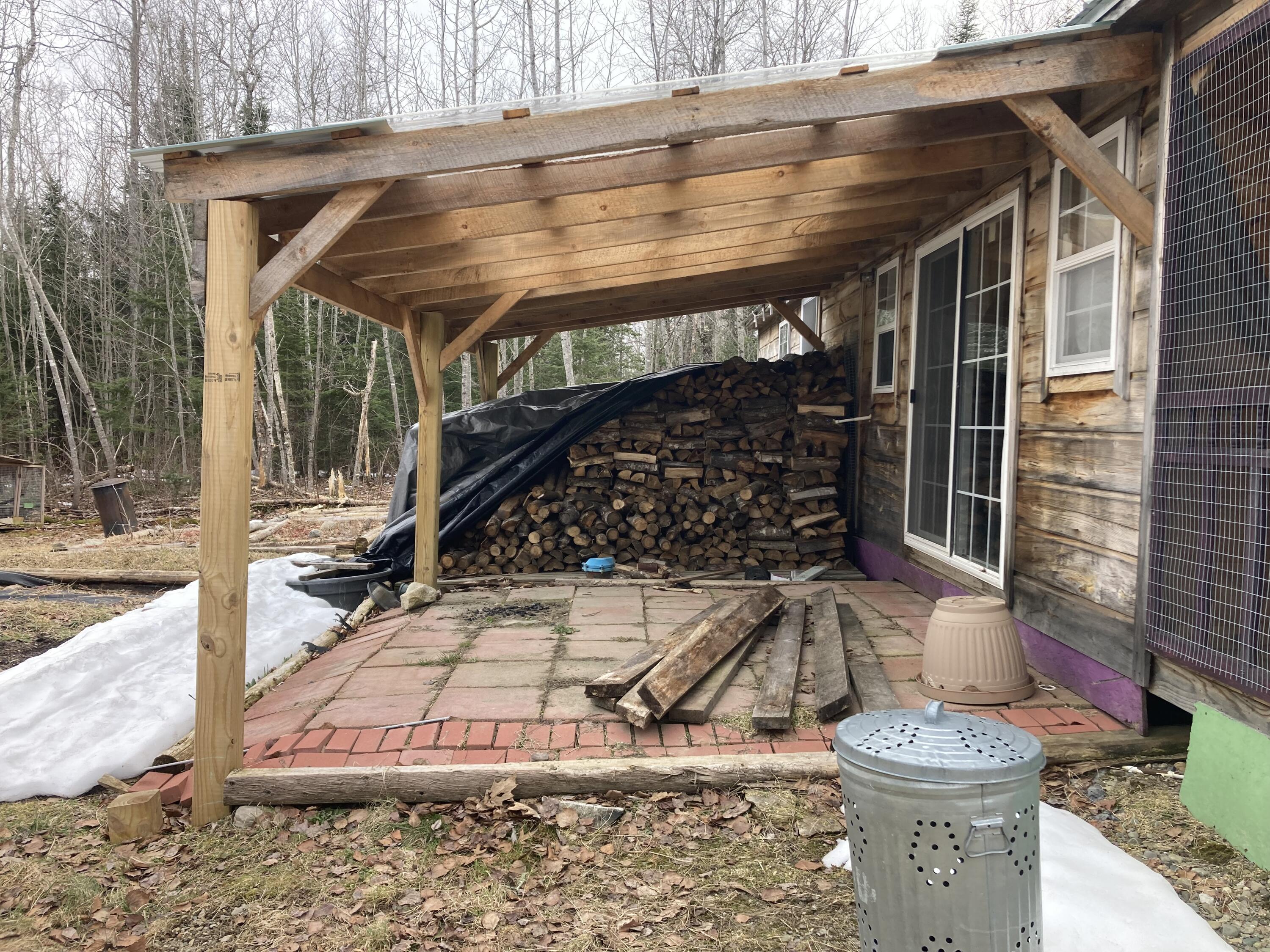 124 Young Lane Burnham, ME 04922 - Photo 2 of 40 Covered porch with dry firewood