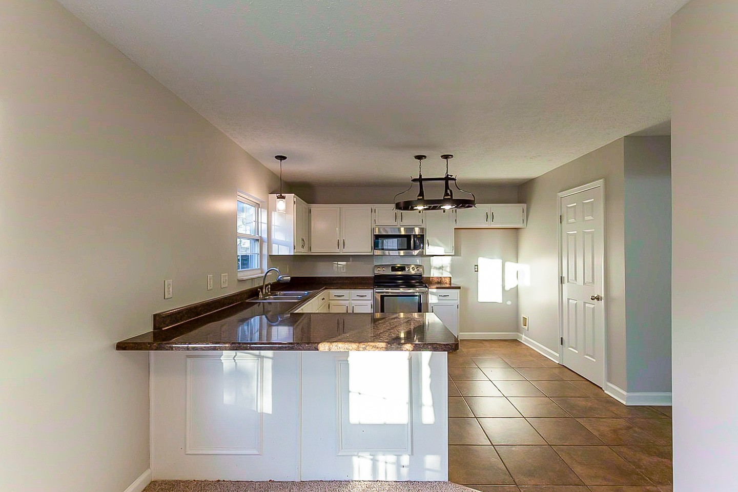 1945 Portway Road Spring Hill, TN 37174 - Photo 4 of 26 a kitchen with kitchen island granite countertop a sink cabinets and stainless steel appliances