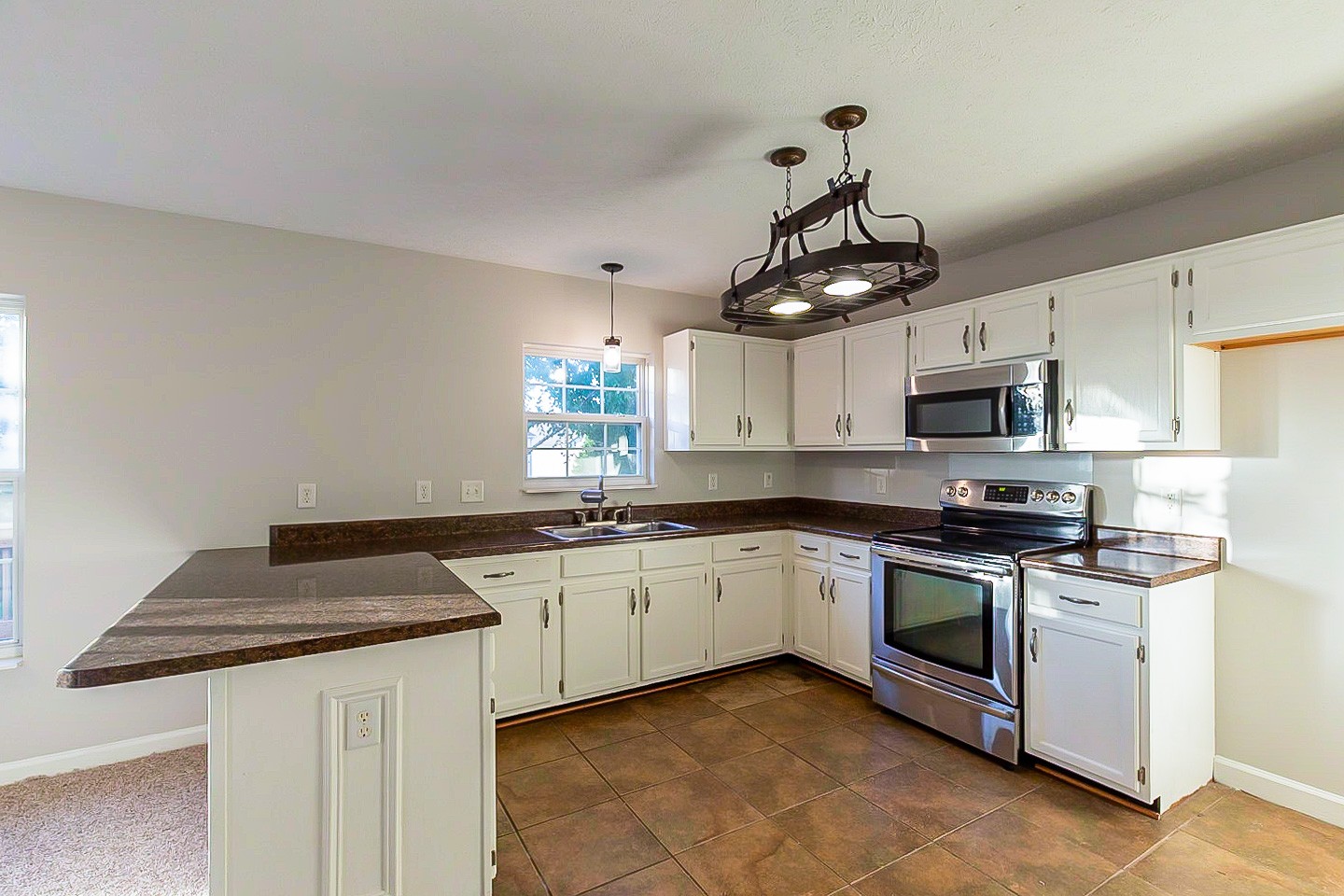 1945 Portway Road Spring Hill, TN 37174 - Photo 8 of 26 a kitchen with granite countertop stainless steel appliances a sink dishwasher a stove top oven a counter space and cabinets