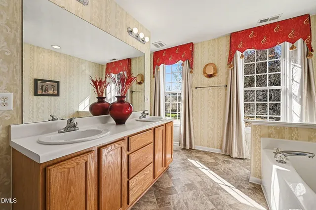a bathroom with a sink vanity and a mirror