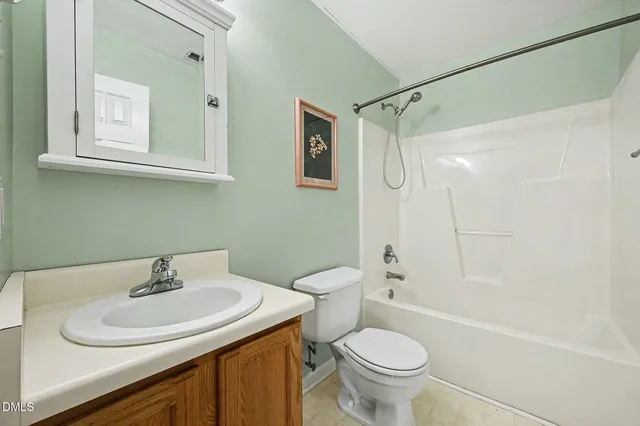 a bathroom with a sink toilet and a mirror