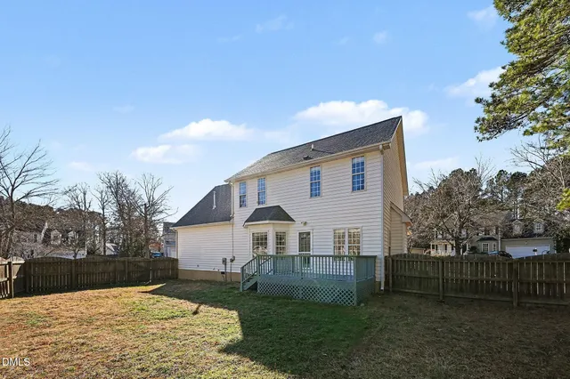 a view of a white house with a yard