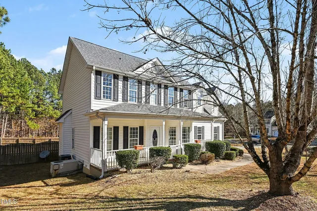 a front view of a house with yard porch and seating space