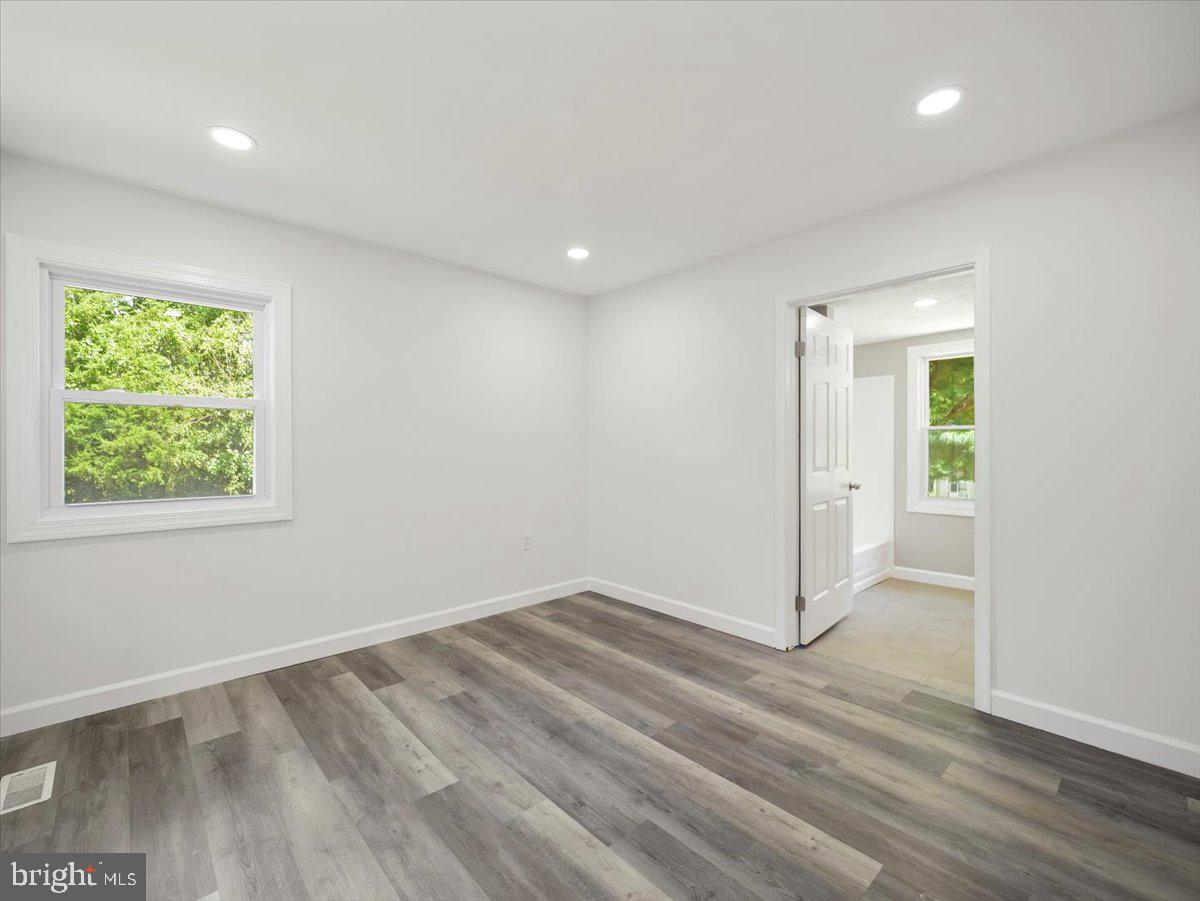 8704 Orndorff Road Thurmont, MD 21788 - Photo 19 of 43 an empty room with wooden floor and windows