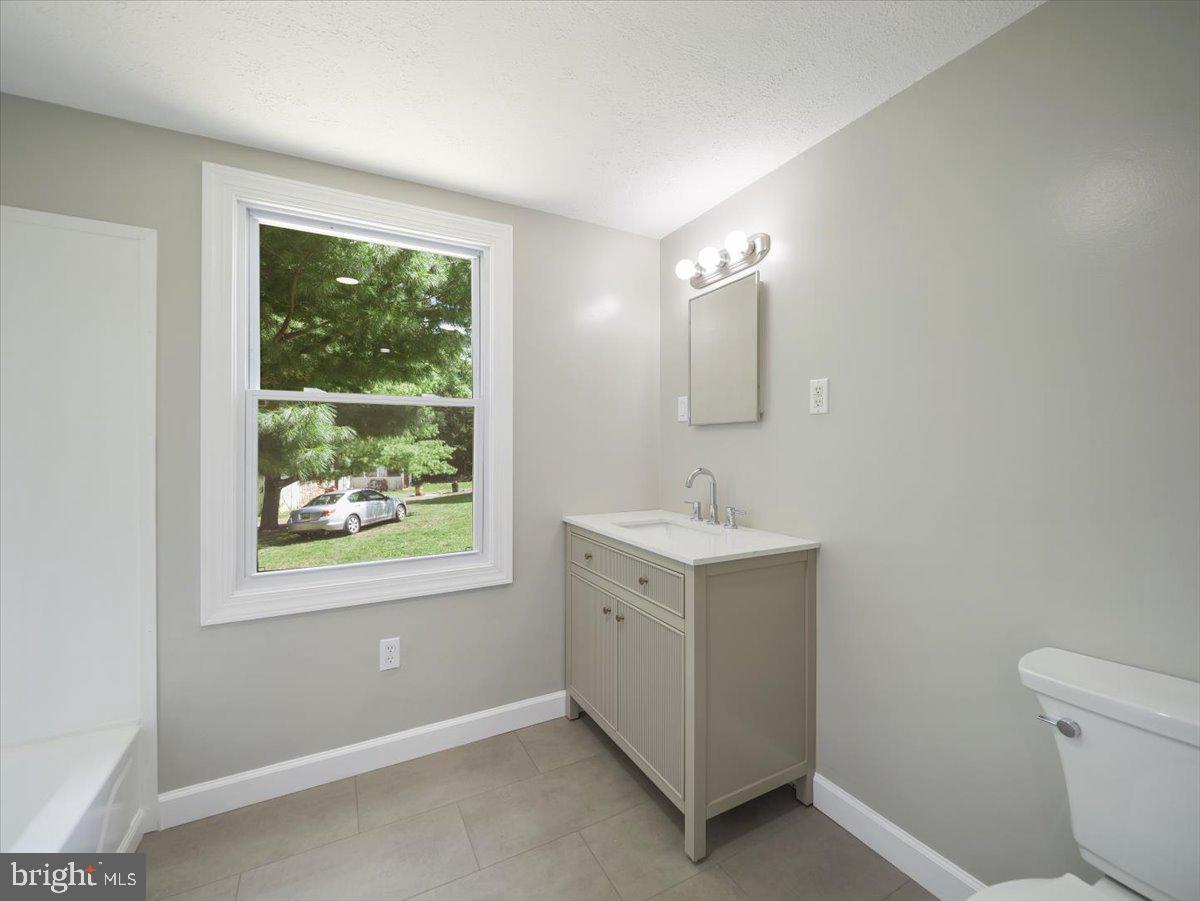 8704 Orndorff Road Thurmont, MD 21788 - Photo 22 of 43 a bathroom with a sink vanity and a toilet