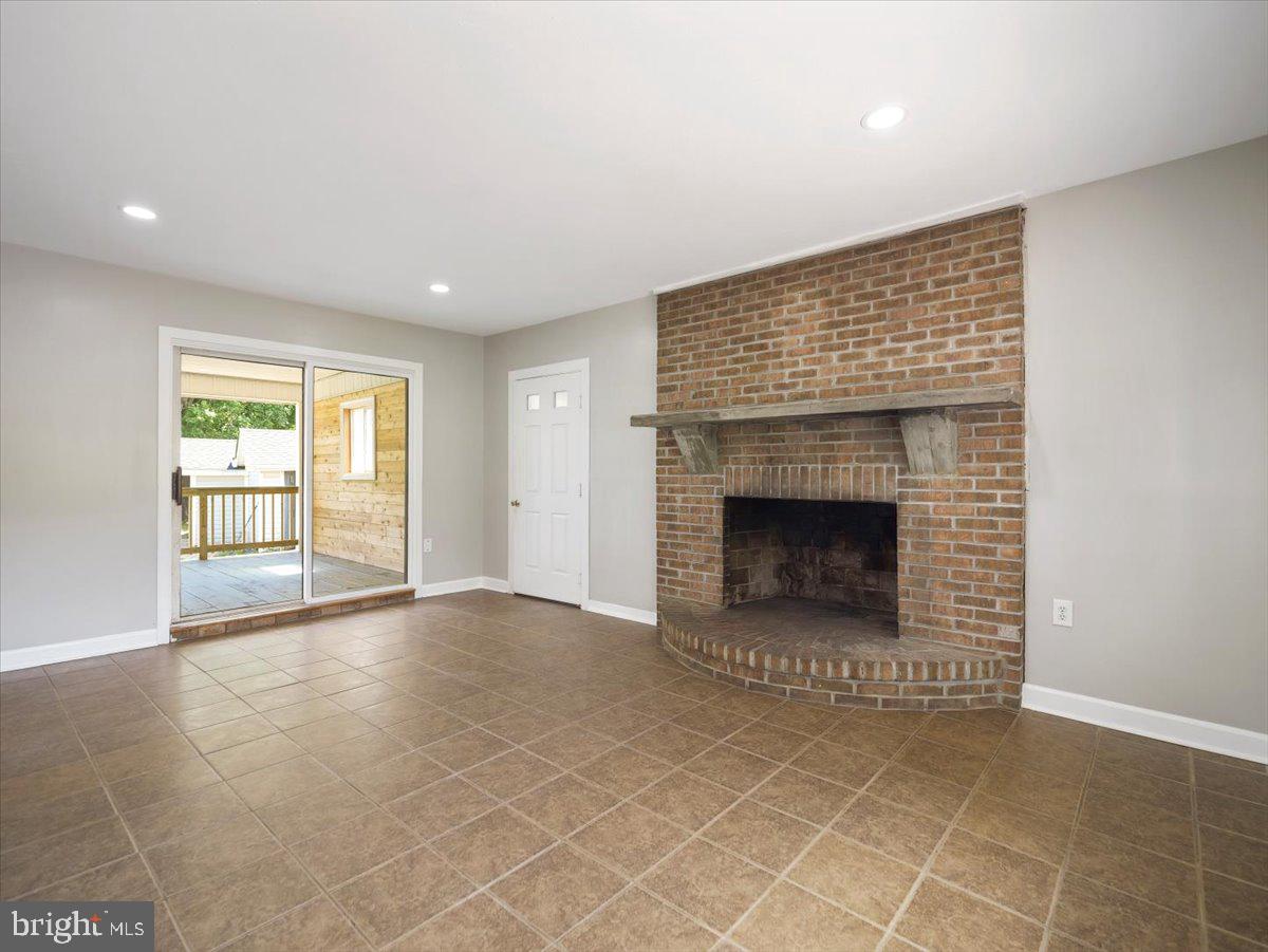 8704 Orndorff Road Thurmont, MD 21788 - Photo 25 of 43 a view of an empty room with a fireplace and a window
