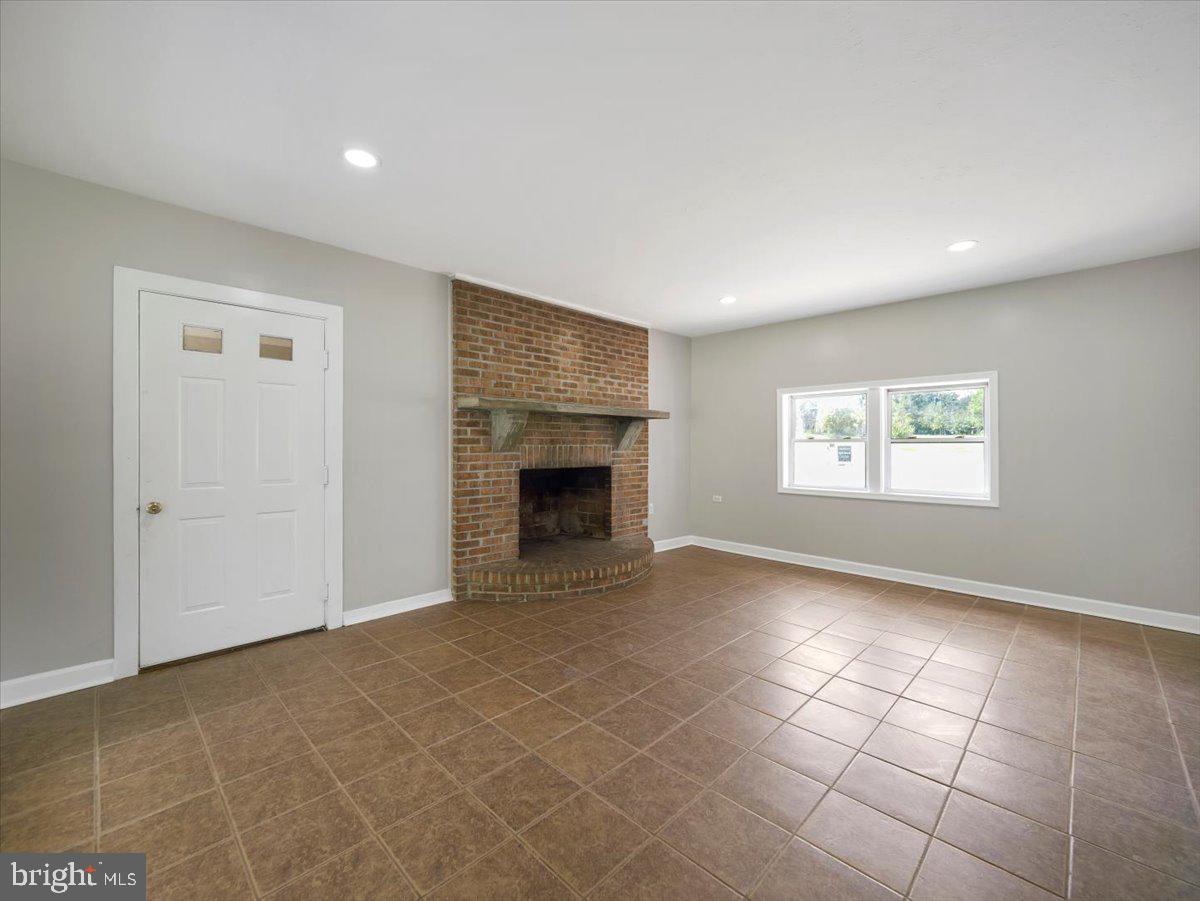8704 Orndorff Road Thurmont, MD 21788 - Photo 26 of 43 a view of an empty room with a fireplace and a window