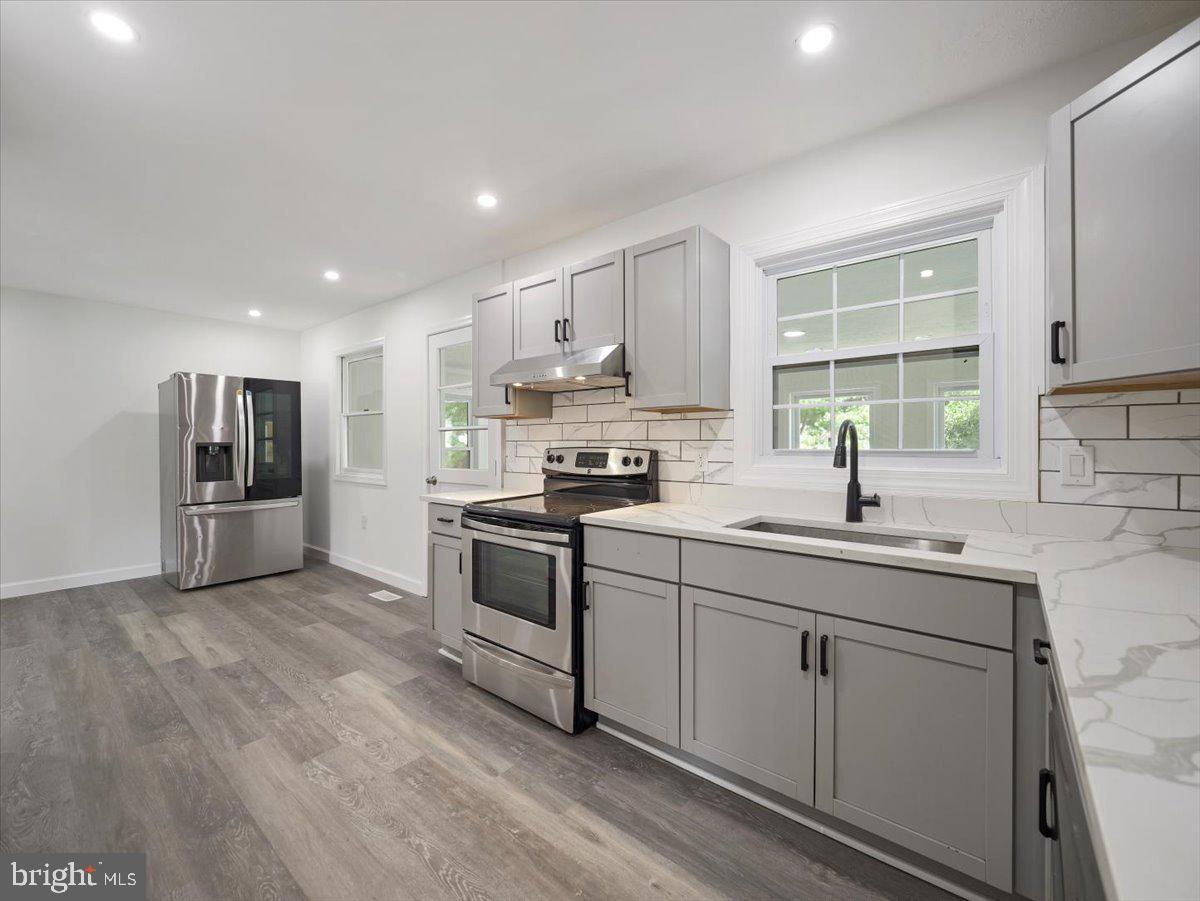 8704 Orndorff Road Thurmont, MD 21788 - Photo 10 of 43 a kitchen with stainless steel appliances granite countertop a sink stove and refrigerator