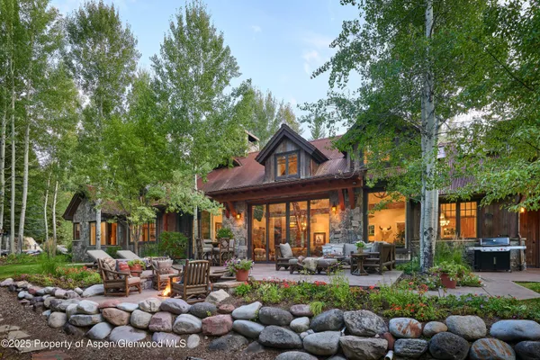 a living room with furniture ceiling fan and a window