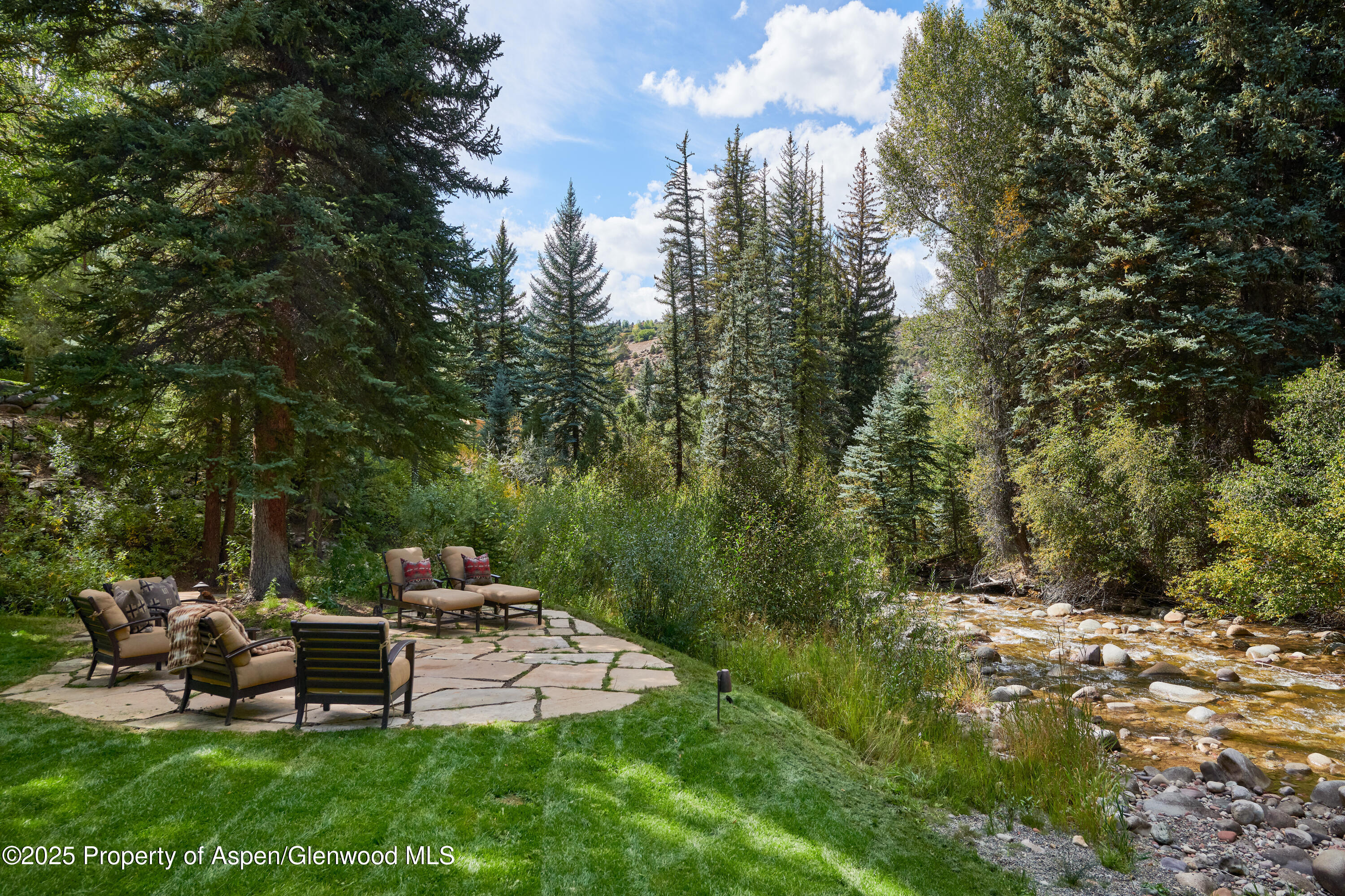 1900-1470 Snowmass Creek Road Snowmass, CO 81654 - Photo 58 of 105 a view of a bench in a garden