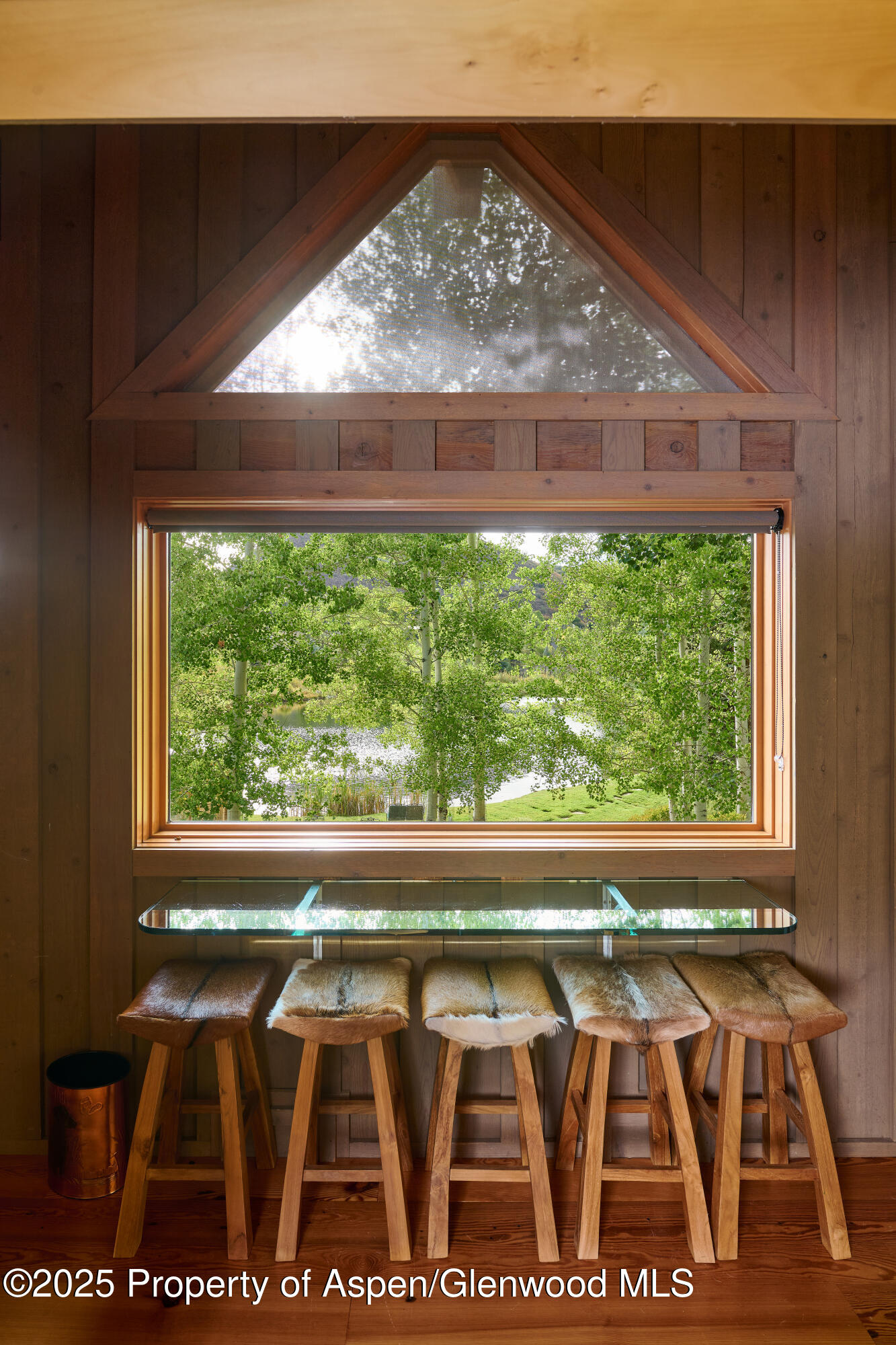 1900-1470 Snowmass Creek Road Snowmass, CO 81654 - Photo 73 of 105 a view of backyard with a large window and wooden floor