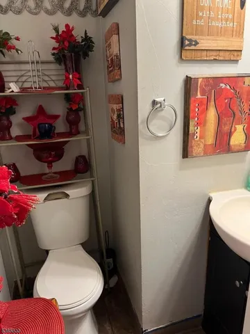 a white toilet sitting next to a bathroom sink and vanity