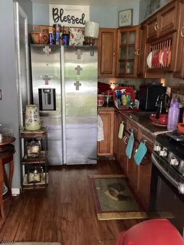a kitchen with stainless steel appliances granite countertop a refrigerator and a stove