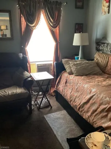 a bedroom with a bed chair and a window