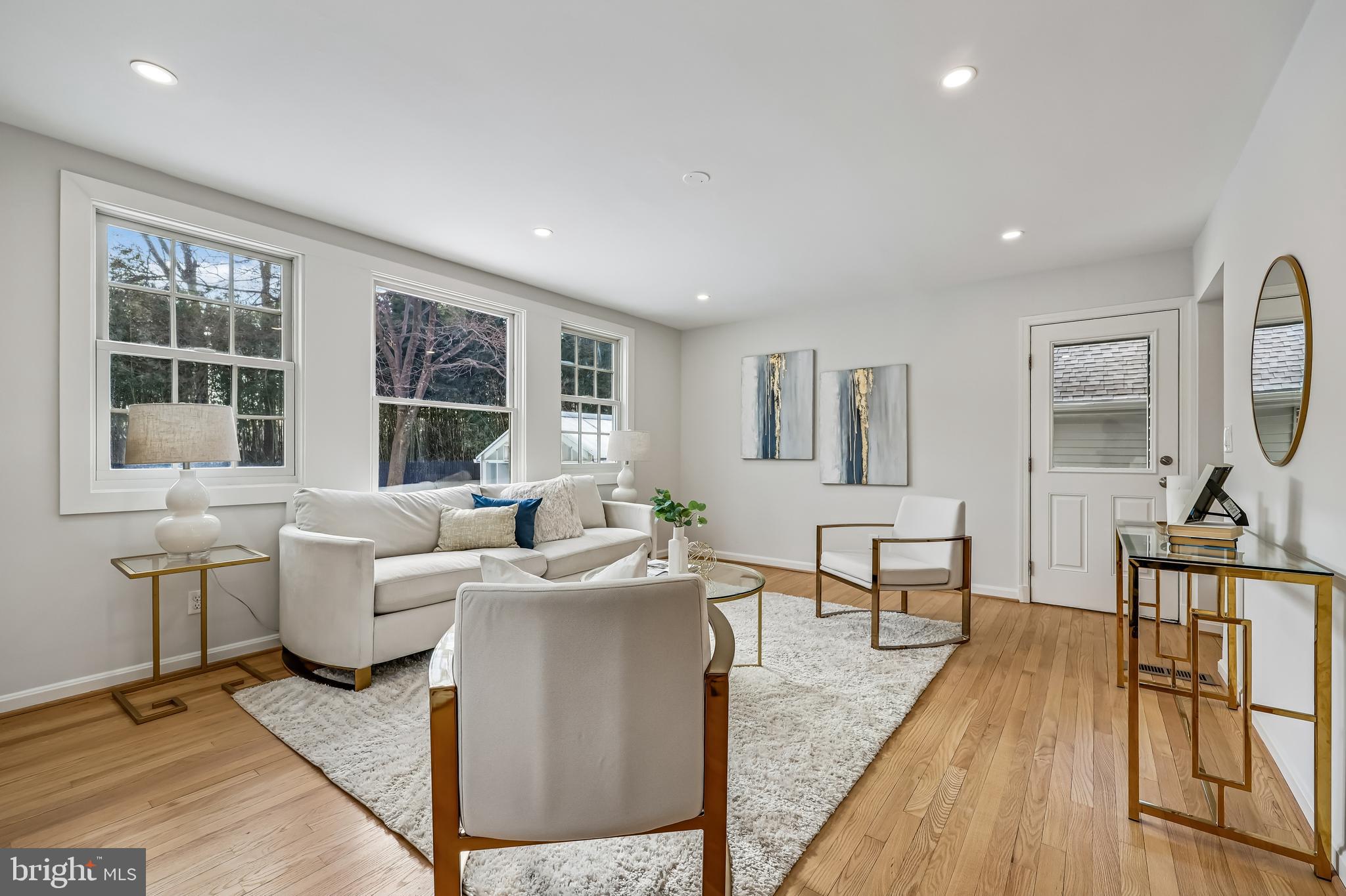 721 Mapleton Road Rockville, MD 20850 - Photo 12 of 36 a living room with furniture a flat screen tv and large windows