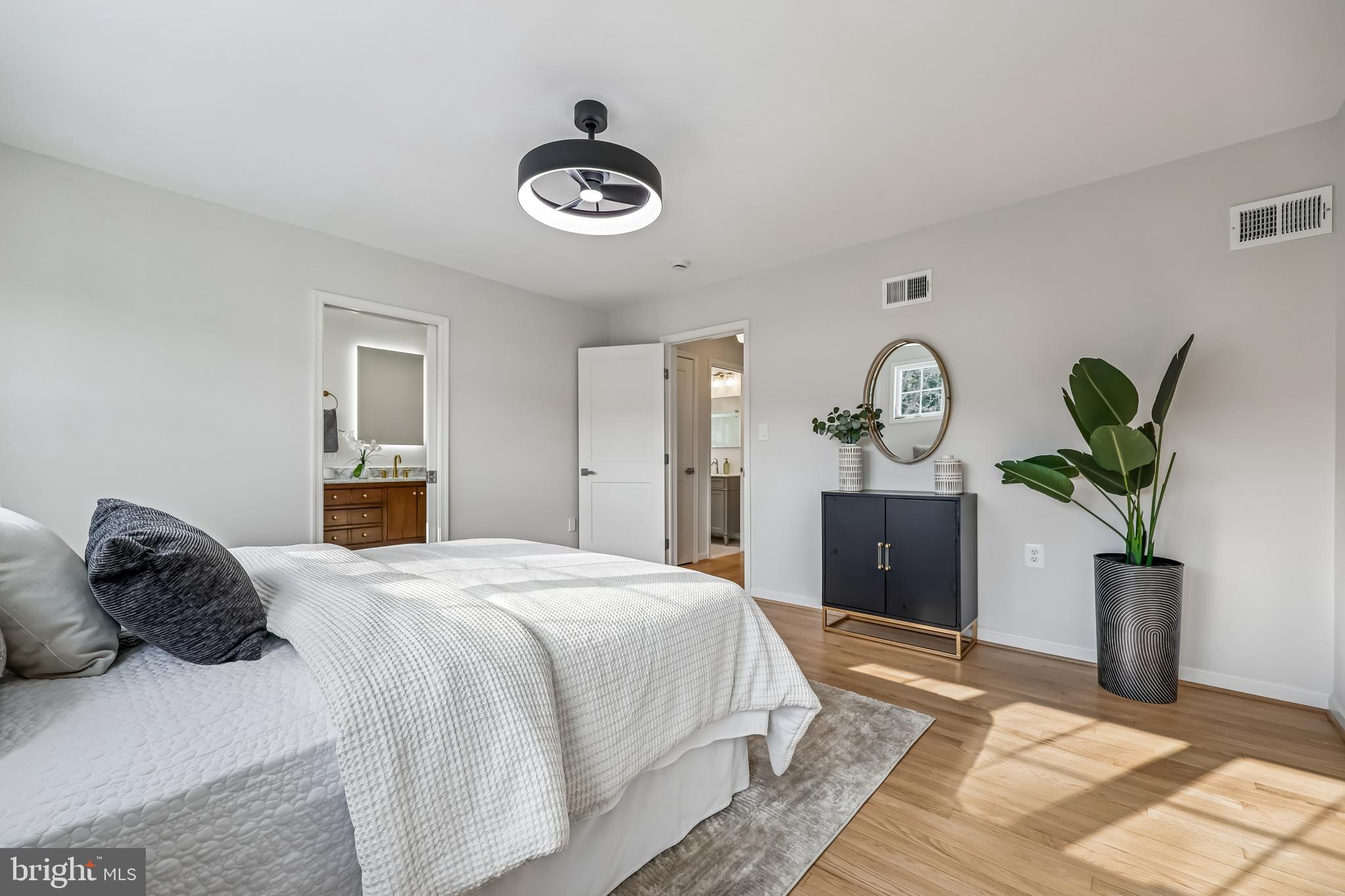 721 Mapleton Road Rockville, MD 20850 - Photo 21 of 36 a bedroom with a bed and a chandelier