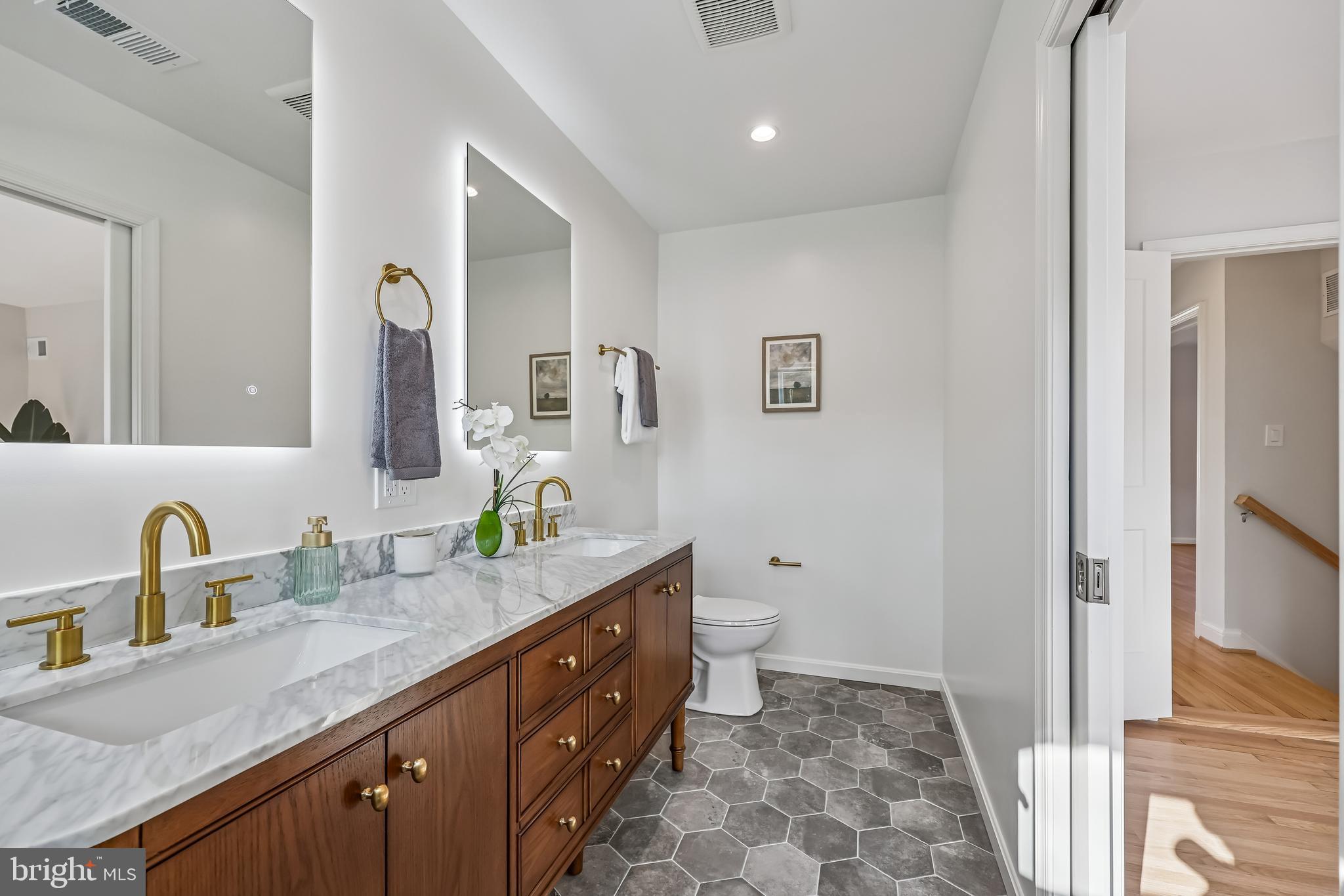 721 Mapleton Road Rockville, MD 20850 - Photo 24 of 36 a bathroom with a granite countertop sink and a mirror