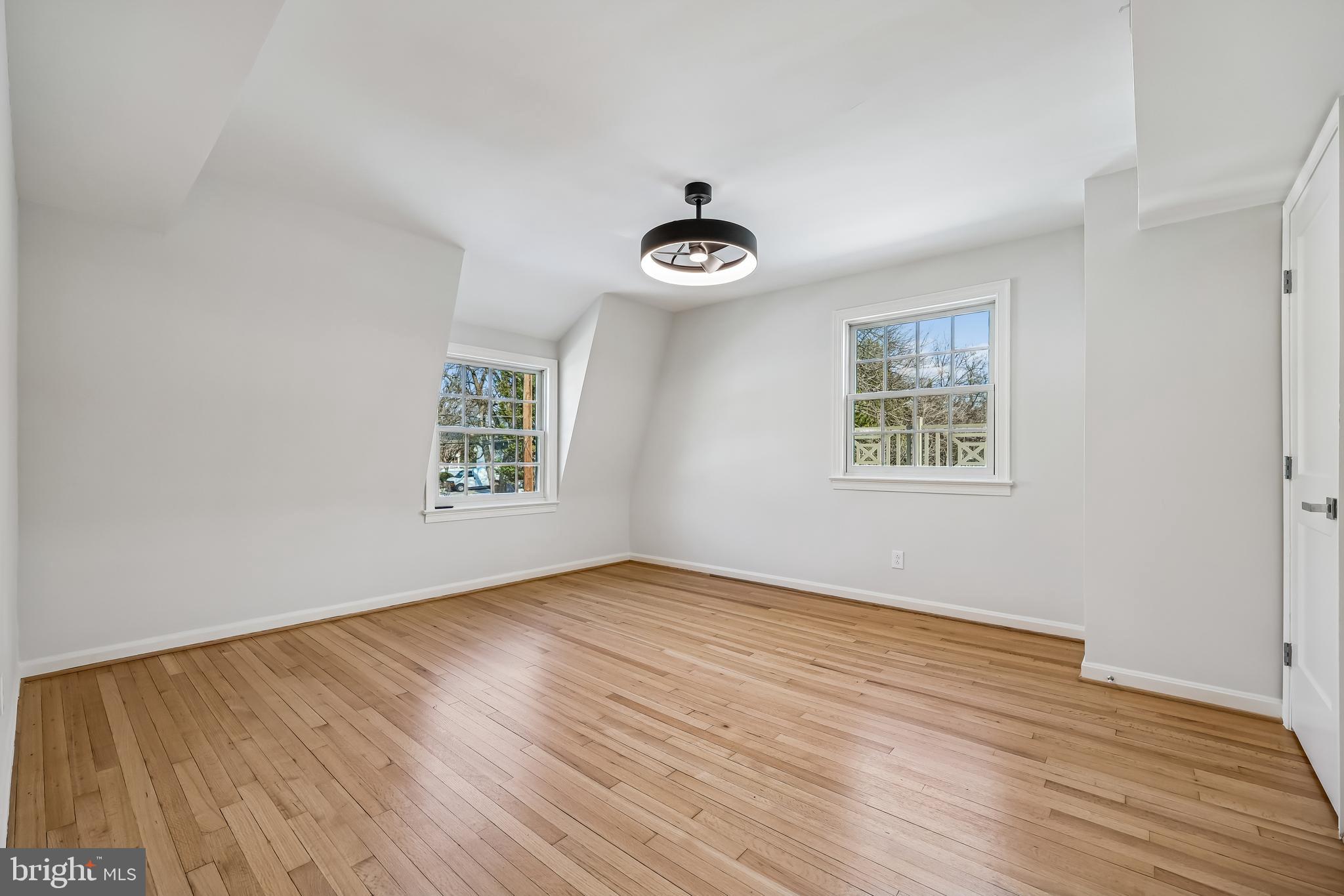 721 Mapleton Road Rockville, MD 20850 - Photo 27 of 36 a view of an empty room with wooden floor and a window