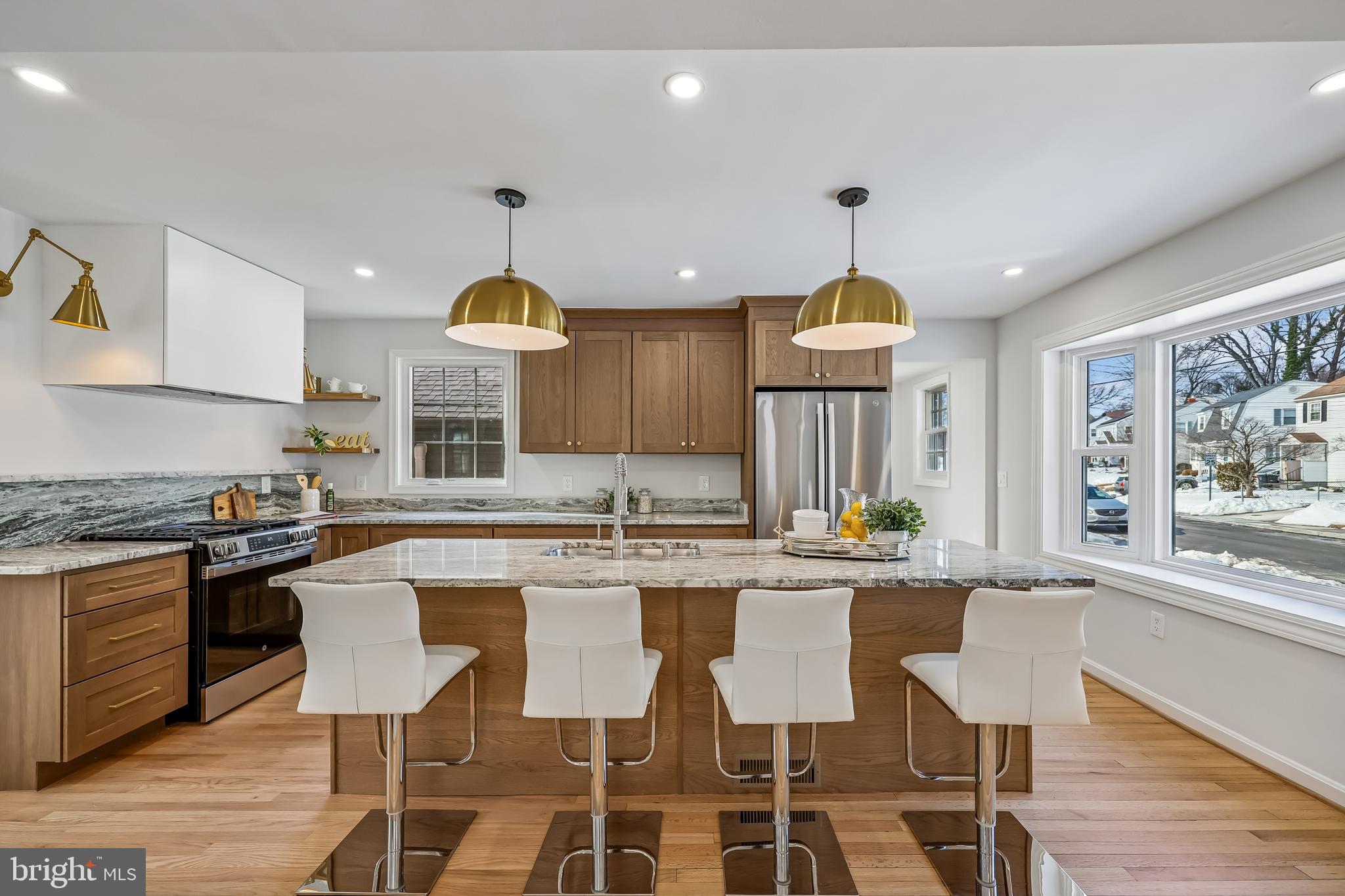 721 Mapleton Road Rockville, MD 20850 - Photo 5 of 36 a kitchen with kitchen island granite countertop a stove a sink a dining table and chairs