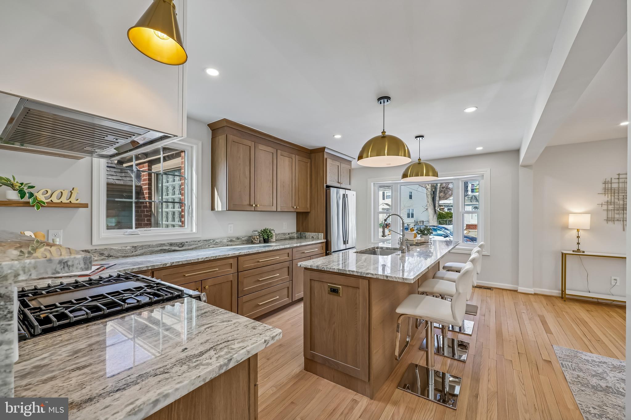 721 Mapleton Road Rockville, MD 20850 - Photo 6 of 36 a kitchen with a stove a sink a dining table and chairs