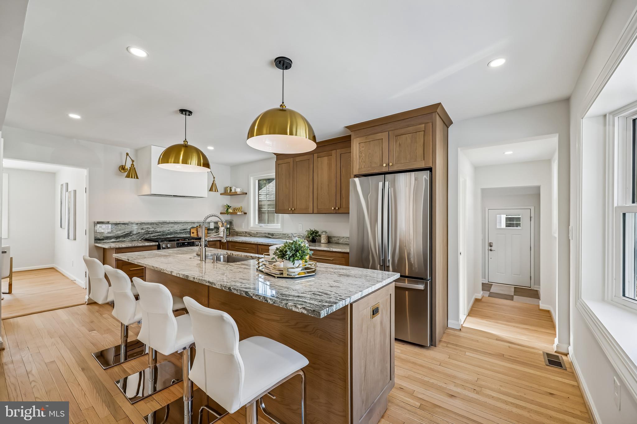 721 Mapleton Road Rockville, MD 20850 - Photo 7 of 36 a kitchen with stainless steel appliances granite countertop a sink a stove a refrigerator and island with wooden floor