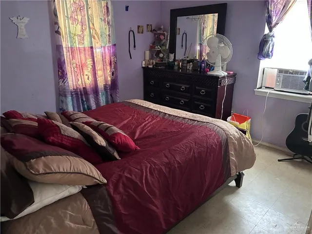 a bedroom with a bed and a dresser