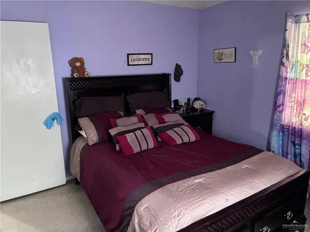 a bedroom with a bed and a table