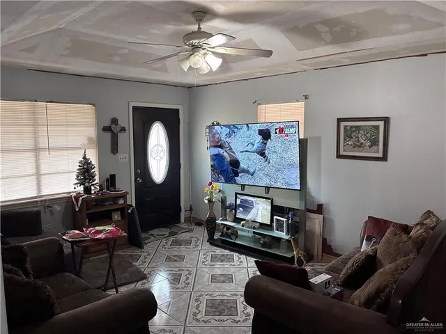 a living room with furniture and a mirror