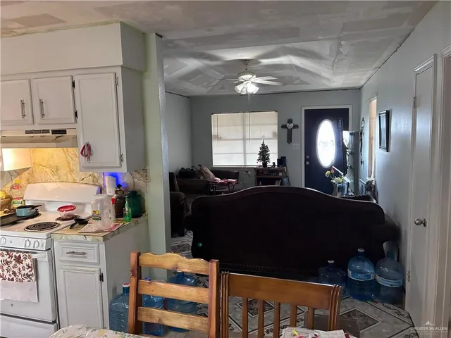 a living room with furniture and a mirror
