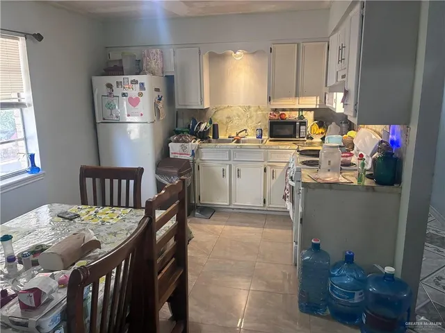 a kitchen with a refrigerator and microwave